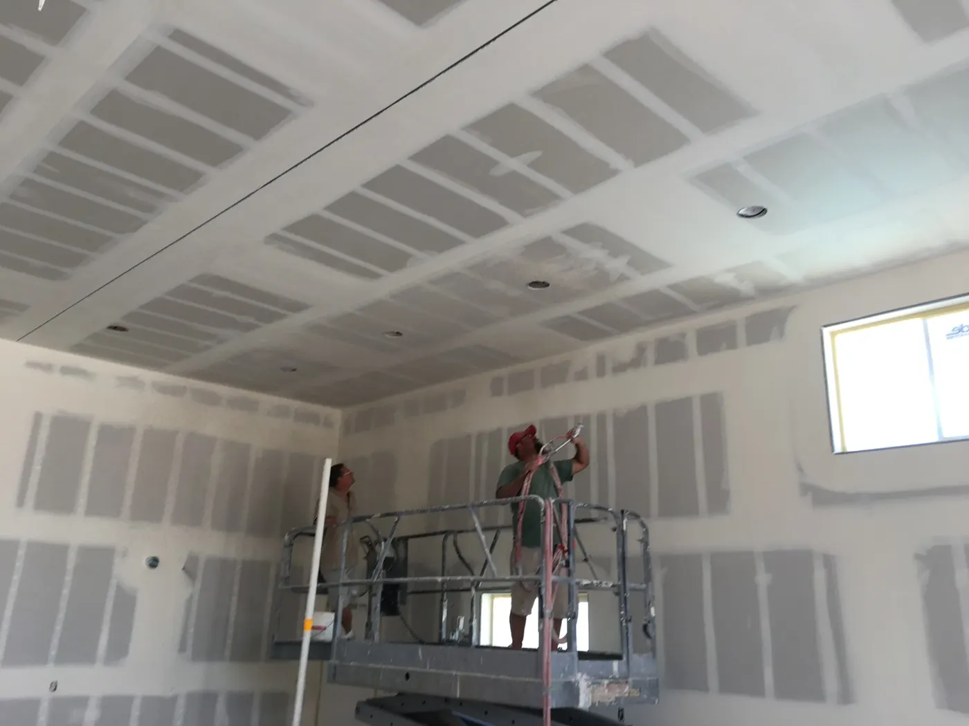 Drywall and ceiling finish work underway inside a K&R project