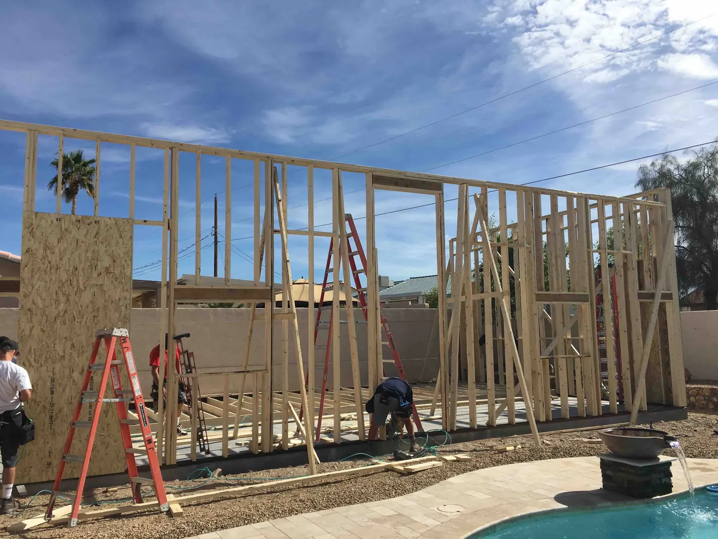 Wood framing under a clear sky on a K&R project site