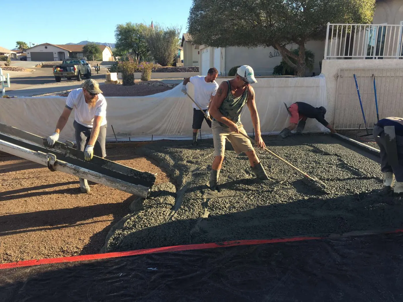 Crew coordinating concrete foundation work on a K&R site